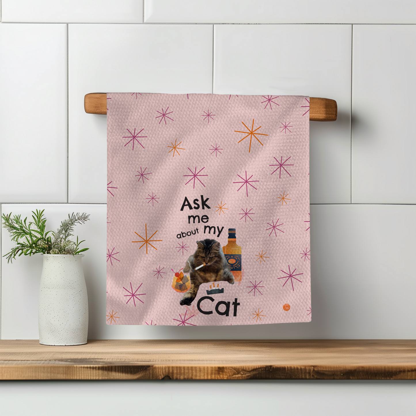 Pink towel with stars, featuring the text "Ask me about my Cat" and an illustration of a cat and a bottle.