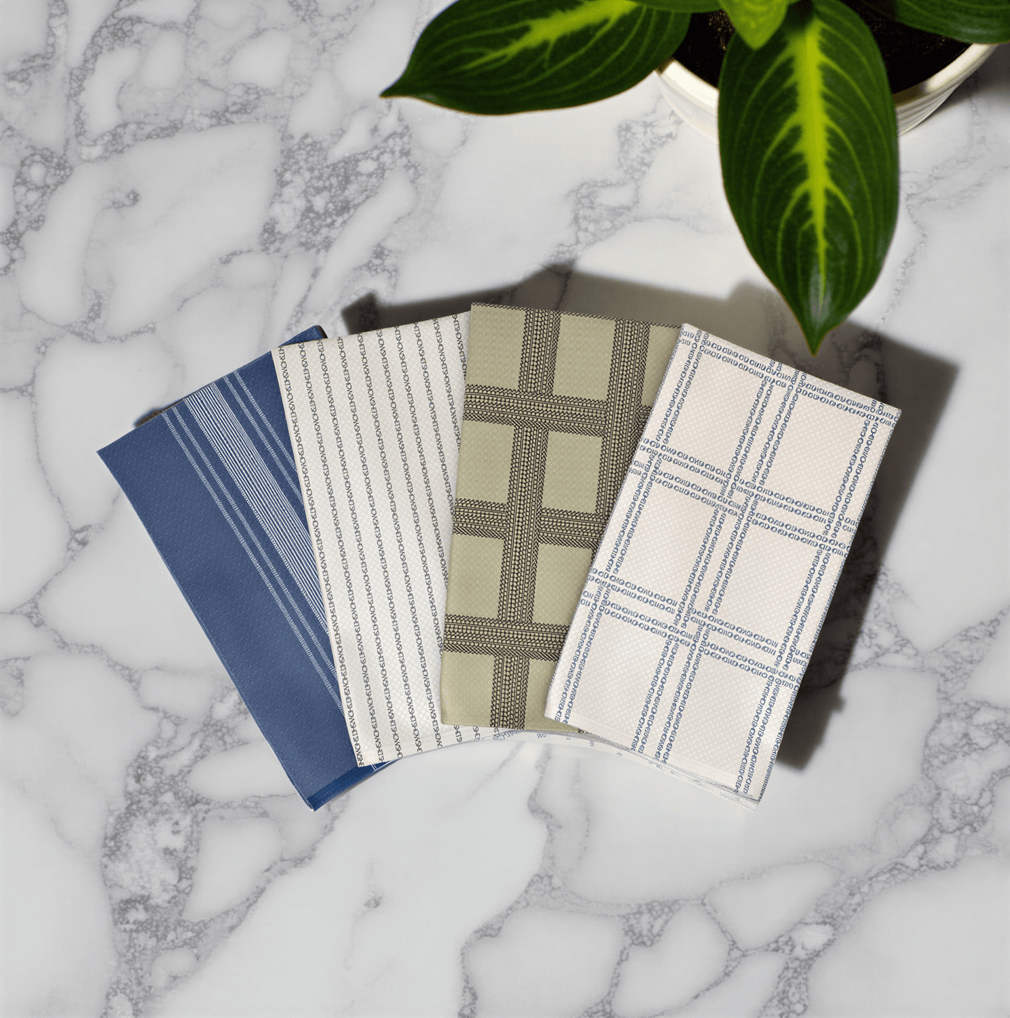 Shitshow plaid towel in retro colors, featuring blue, green, and beige patterns on a marble surface.