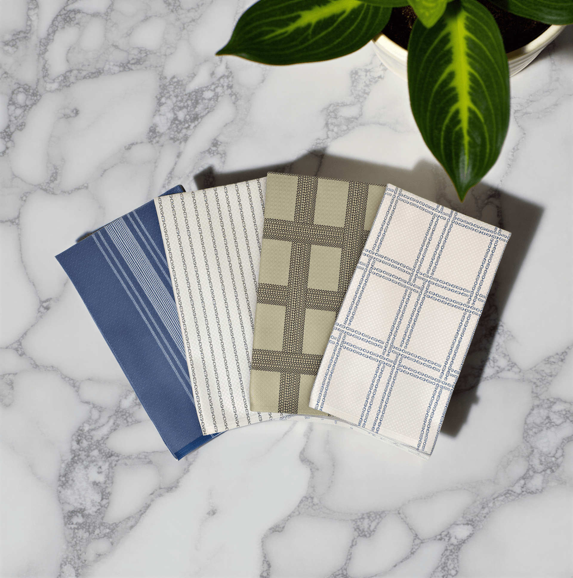 Shitshow plaid towel in retro colors, featuring blue, green, and beige patterns on a marble surface.