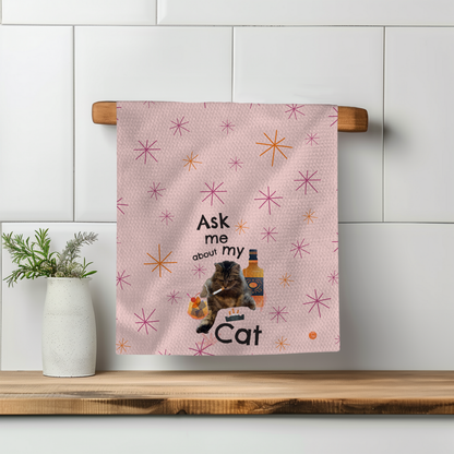 Pink towel with stars, featuring the text "Ask me about my Cat" and an illustration of a cat and a bottle.