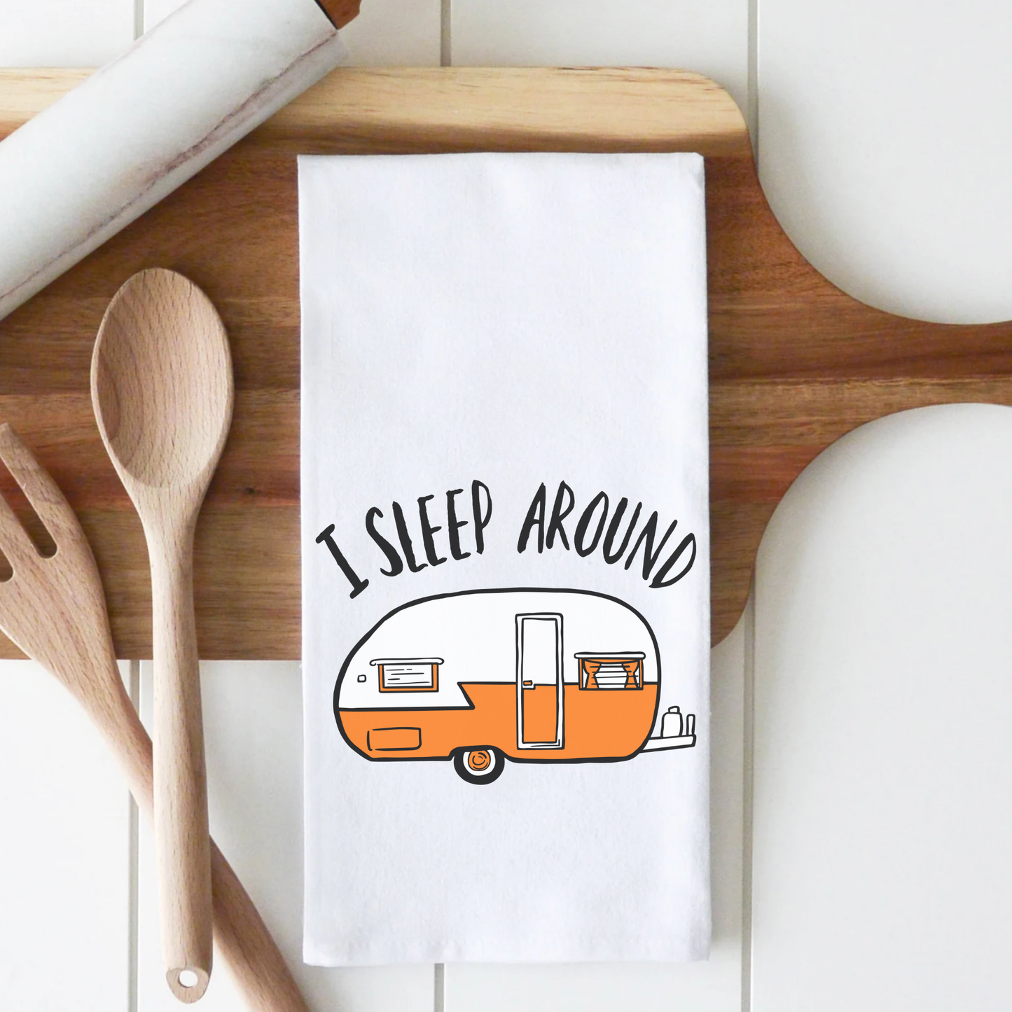 Funny superior cotton tea towel featuring an orange camper illustration and the text "I sleep around.