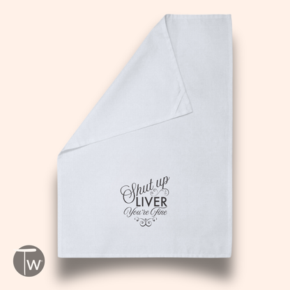 White cotton tea towel featuring the text "Shut up LIVER You're Fine" in black cursive font.