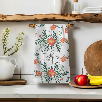 Vintage Fresh Out Perfect Towel with floral design, hanging on a wooden shelf above a white pitcher and fruit.