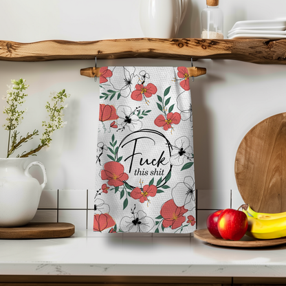 Vintage Fk This Shit towel featuring floral patterns in red and green, hanging on a wooden shelf with kitchen decor.
