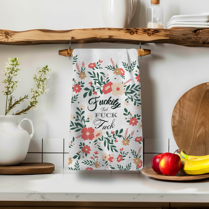 Vintage Fkity Fk Perfect Towel with floral design, hanging on a wooden rack in a kitchen setting.