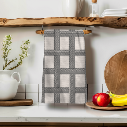 Vintage classic design kitchen tea towel with a grid pattern, hanging on a wooden shelf with kitchen decor.