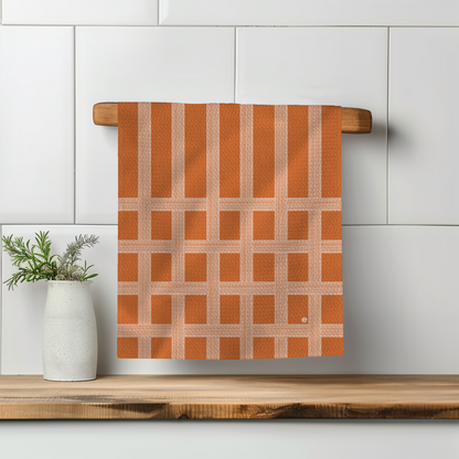 Vintage Shitshow Stripes towel in fall colors, hanging on a wooden rack with a white vase and plant nearby.