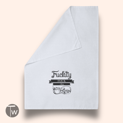 Adult Word Fuck cotton tea towel in light gray with black text and decorative design.