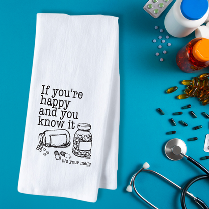 White cotton tea towel featuring a humorous design with the text "If you're happy and you know it, it's your meds" and ill...