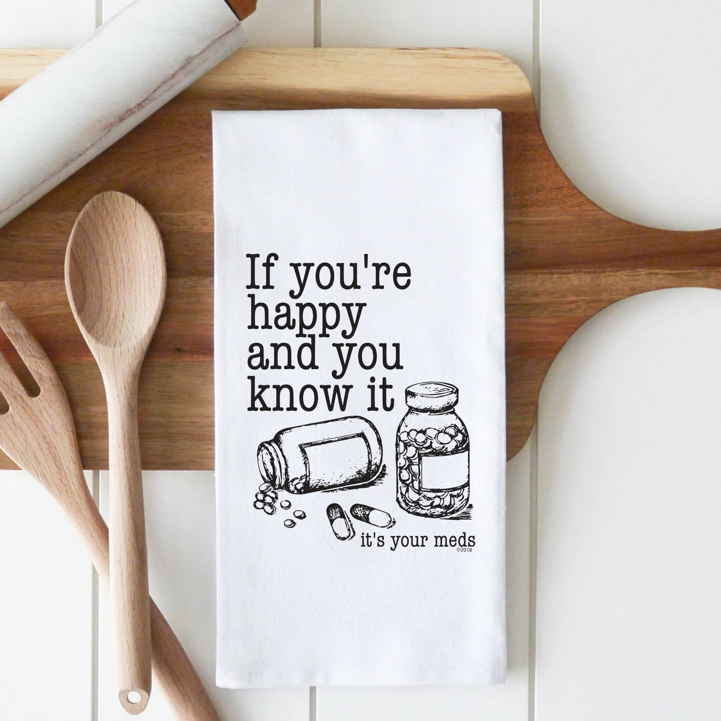 White cotton tea towel featuring the text "If you're happy and you know it, it's your meds" with a graphic of a pill bottl...