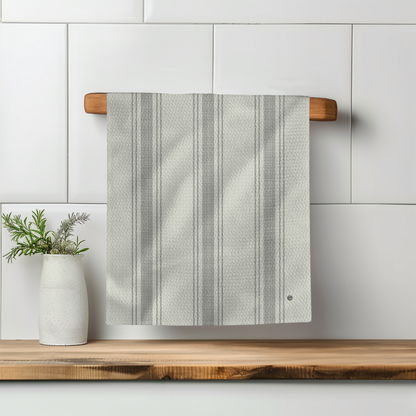 Pardon My French Stripe Illusion towel hanging on a wooden rack, featuring gray stripes against a textured fabric.
