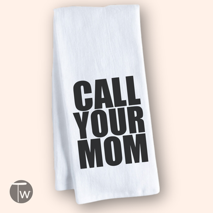 White cotton tea towel with bold black text reading "CALL YOUR MOM.