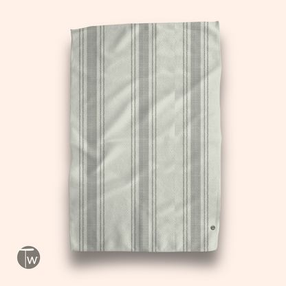 Pardon My French stripe illusion towel with light gray and white stripes on a soft textured fabric.