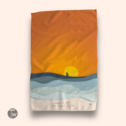 Perfect Towel™ featuring a sunset design with waves and a ship, displaying the text "There it goes, my last fuck.