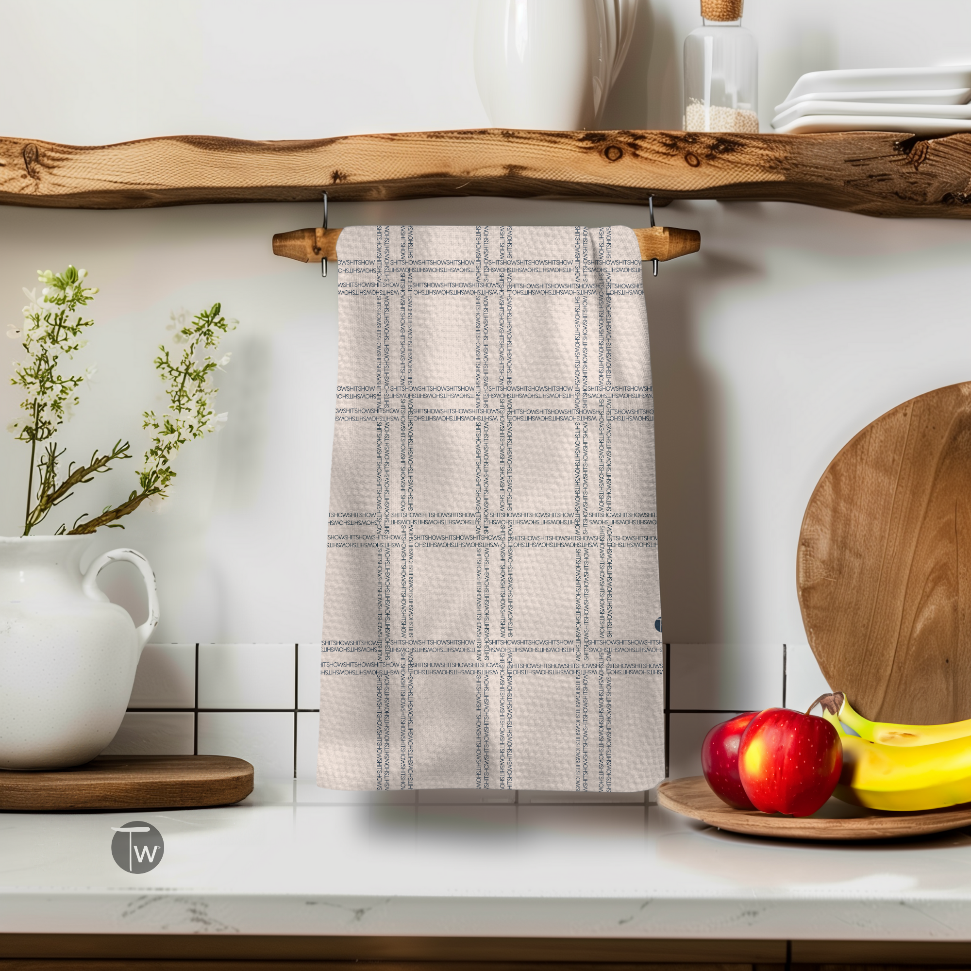 Shitshow plaid towel in beige with a retro pattern, hanging on a wooden shelf above kitchen items.