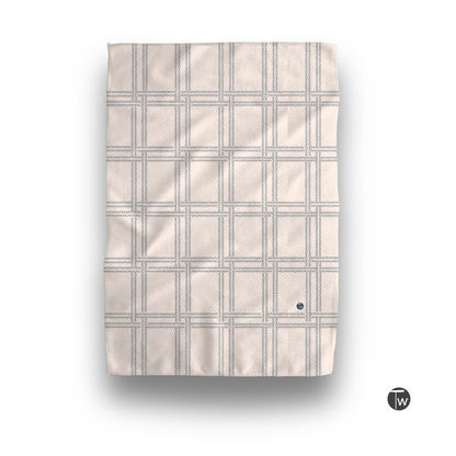 Shitshow plaid towel in retro beige with a textured grid pattern and a small logo in the corner.