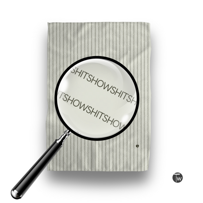 Perfect towel in off-white with Colette stripes, featuring the word "Shitshow" magnified in a glass.