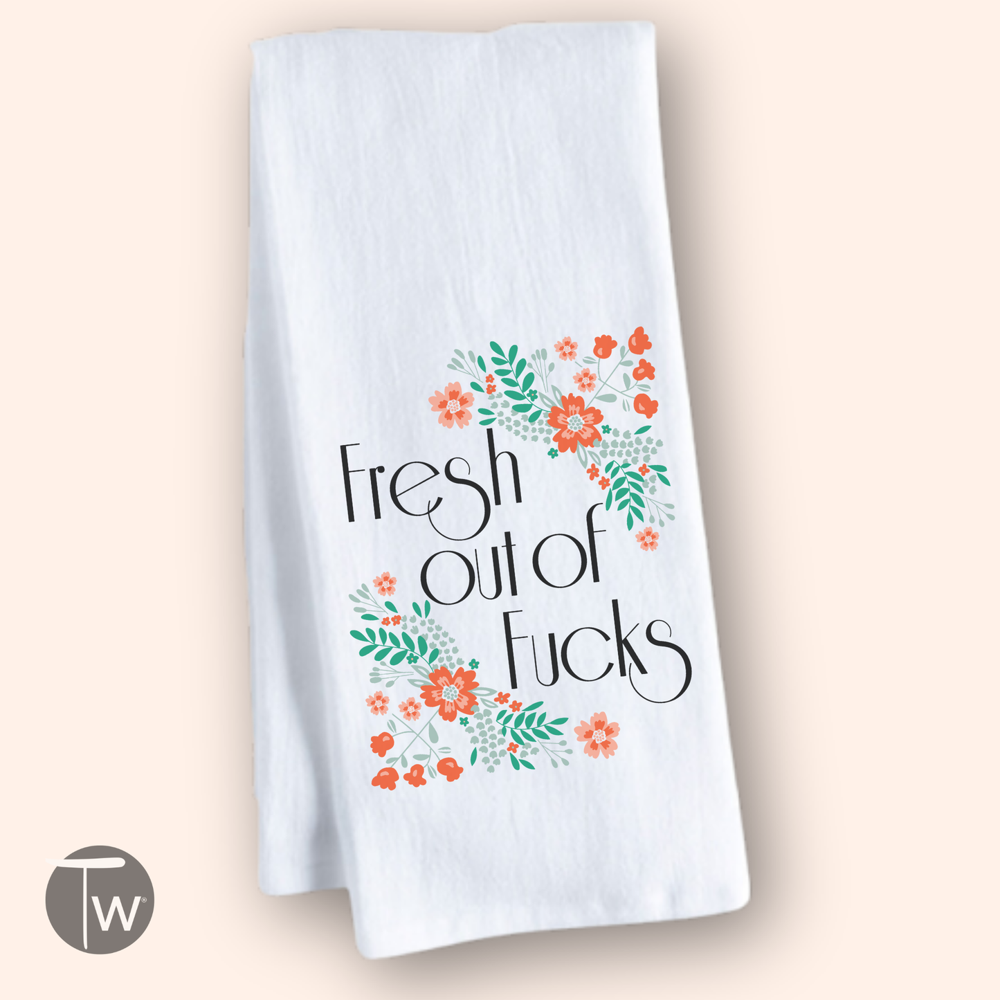 White cotton tea towel with "Fresh out of Fucks" text and colorful floral designs in orange and green.