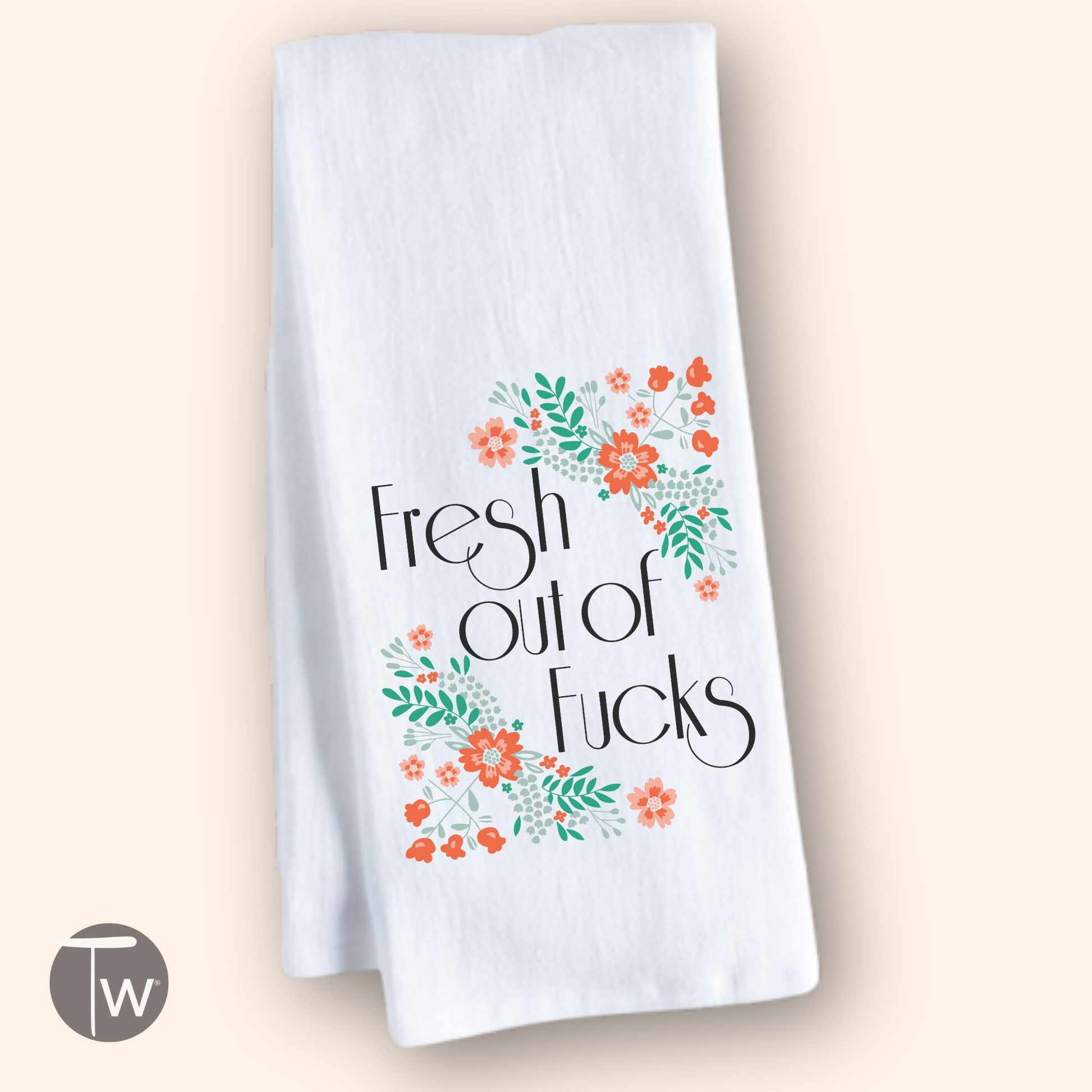 White cotton tea towel with "Fresh out of Fucks" text and colorful floral designs in orange and green.