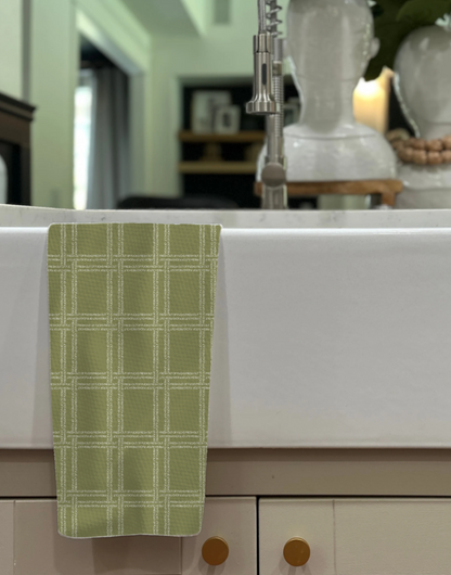 Fresh Out of Fucks green illusion towel hanging over a white countertop, featuring a grid pattern and soft texture.