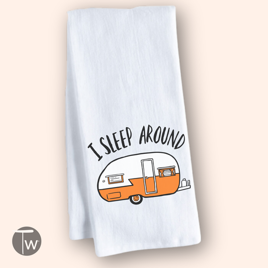 White cotton tea towel featuring an orange retro camper illustration and the text "I sleep around.