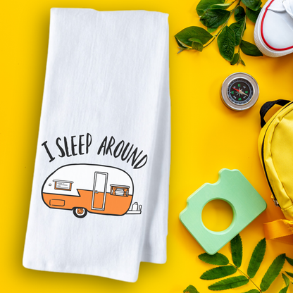 I Sleep Around tea towel featuring a vintage camper design on a white background, surrounded by outdoor items.