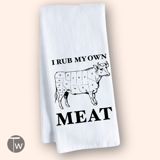 White cotton tea towel featuring a cow diagram and the text "I rub my own meat" in bold black letters.