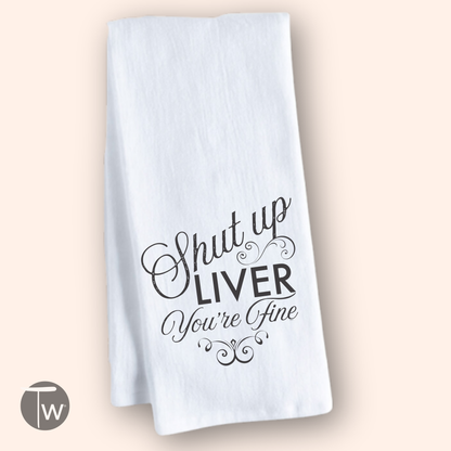 White cotton tea towel featuring the phrase "Shut up LIVER You're Fine" in decorative black lettering.